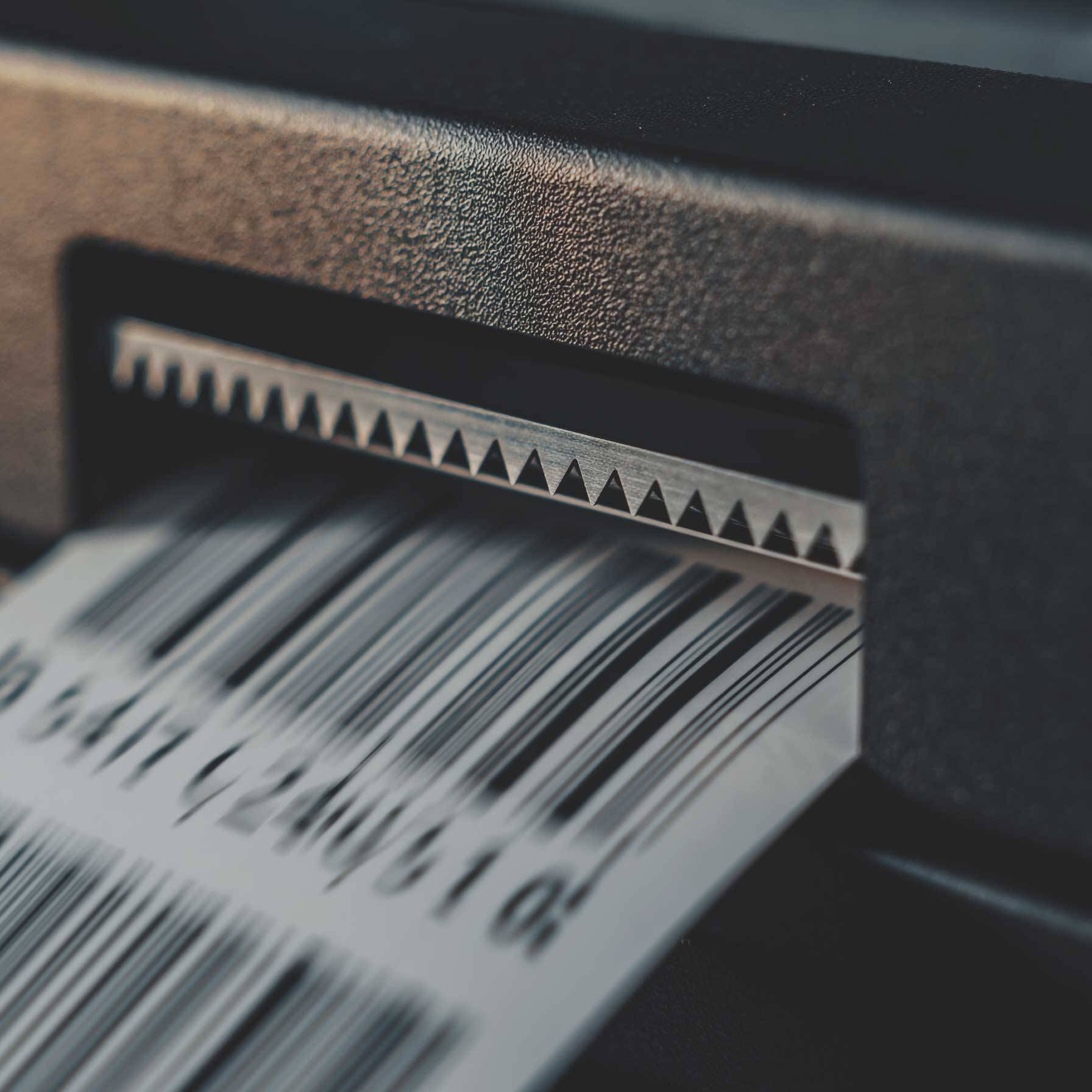 Close up of a printed barcode document, highlighting Dragonfly Tech's secure document routing and commercial print solutions.