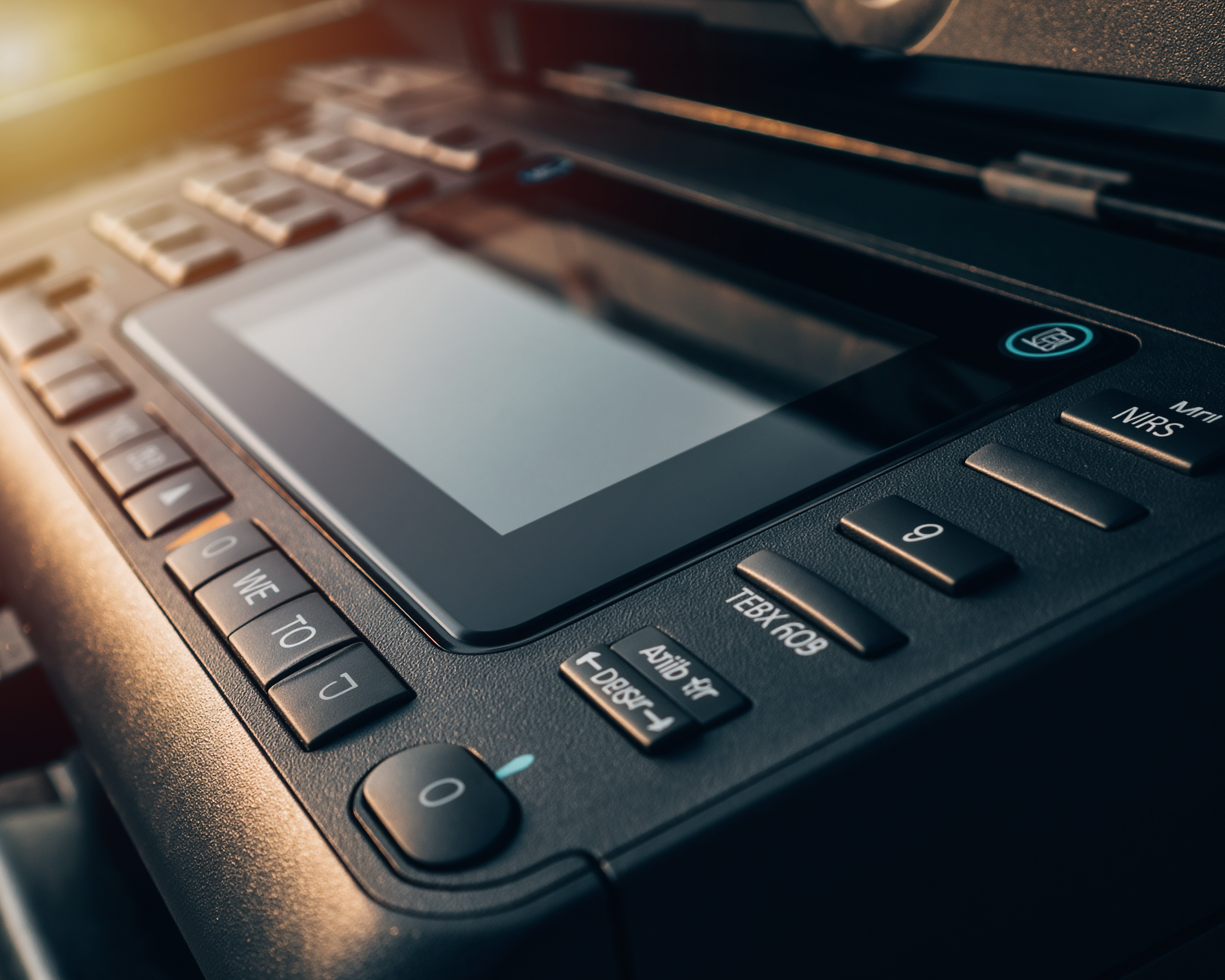 Close-up of a commercial printer control panel, showcasing the seamless hardware integration required for secure business process automation.